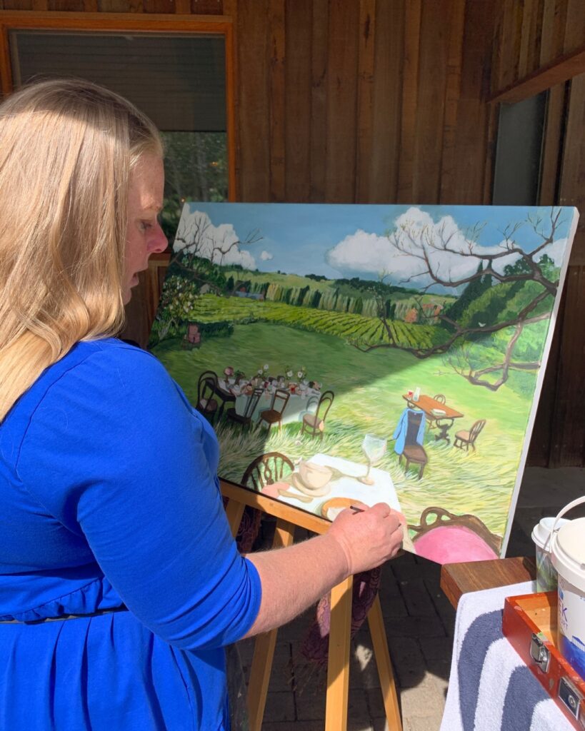 Jacqui Brown painting in her studio, working on a landscape artwork inspired by the Southern Highlands