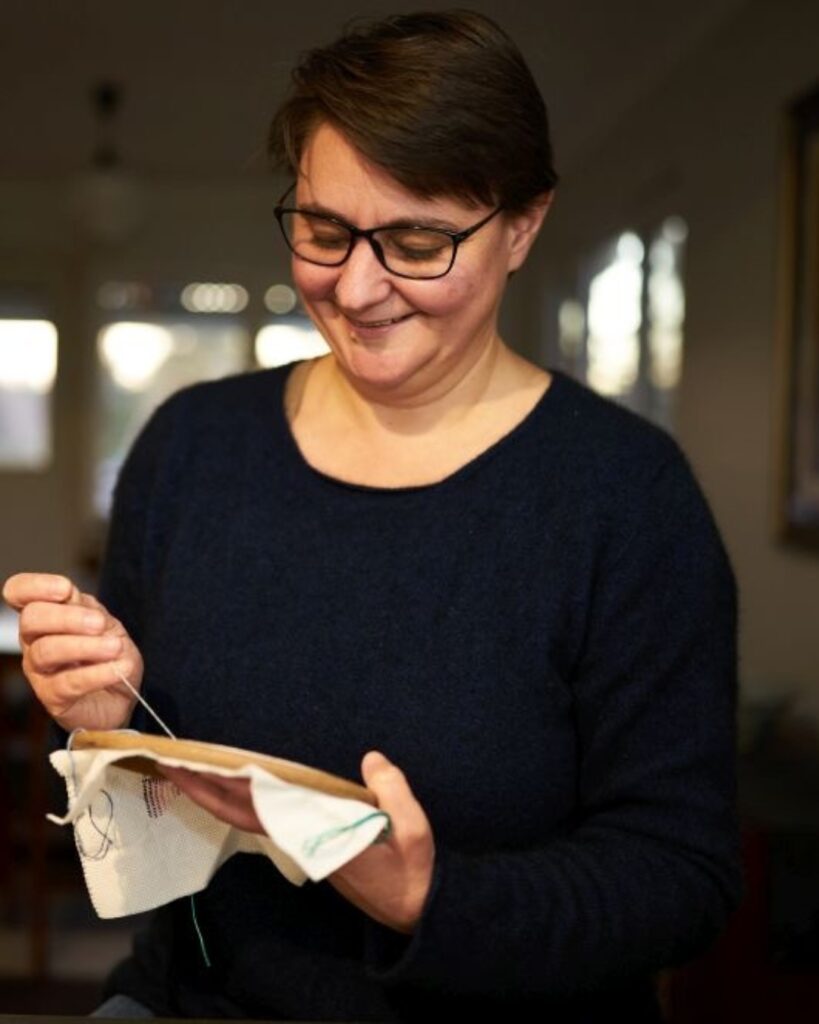 Kate Tribe working on an embroidered textile artwork