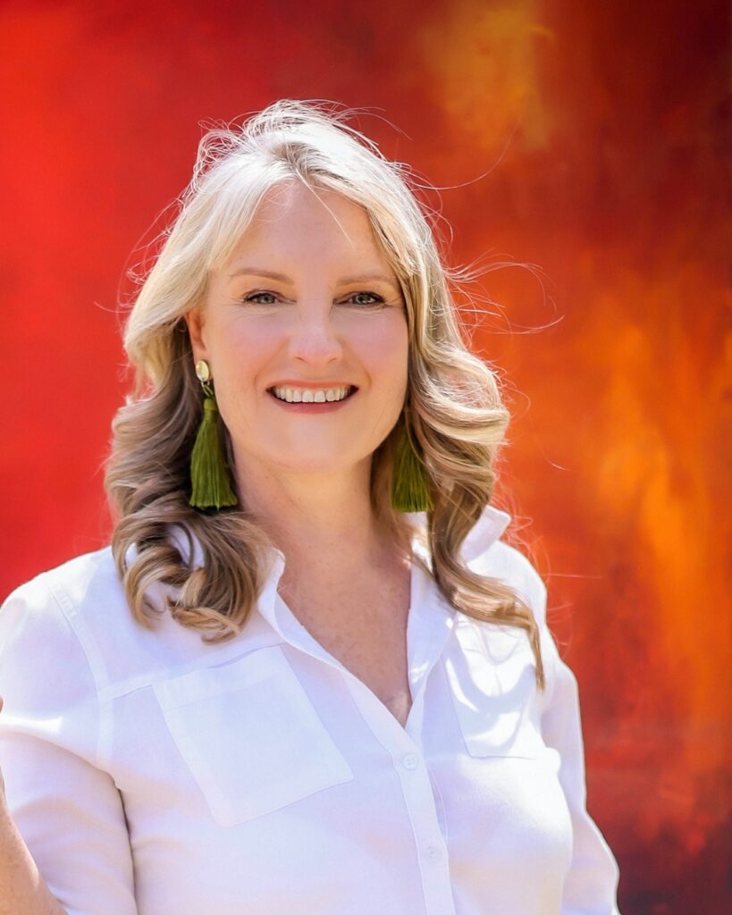 Sarah Norton Creative portrait with vibrant red artwork in the background