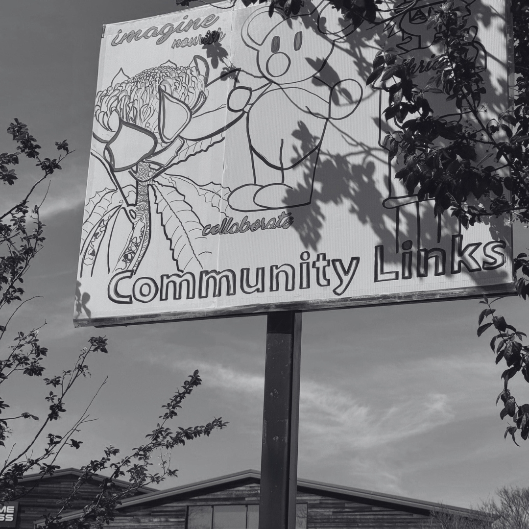 Community Links sign featuring collaborative artwork and community illustrations, representing inclusive arts engagement, wellbeing and cultural connection in the Southern Highlands.